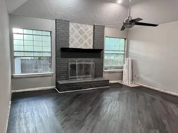 a living room with a flat screen tv and a fireplace