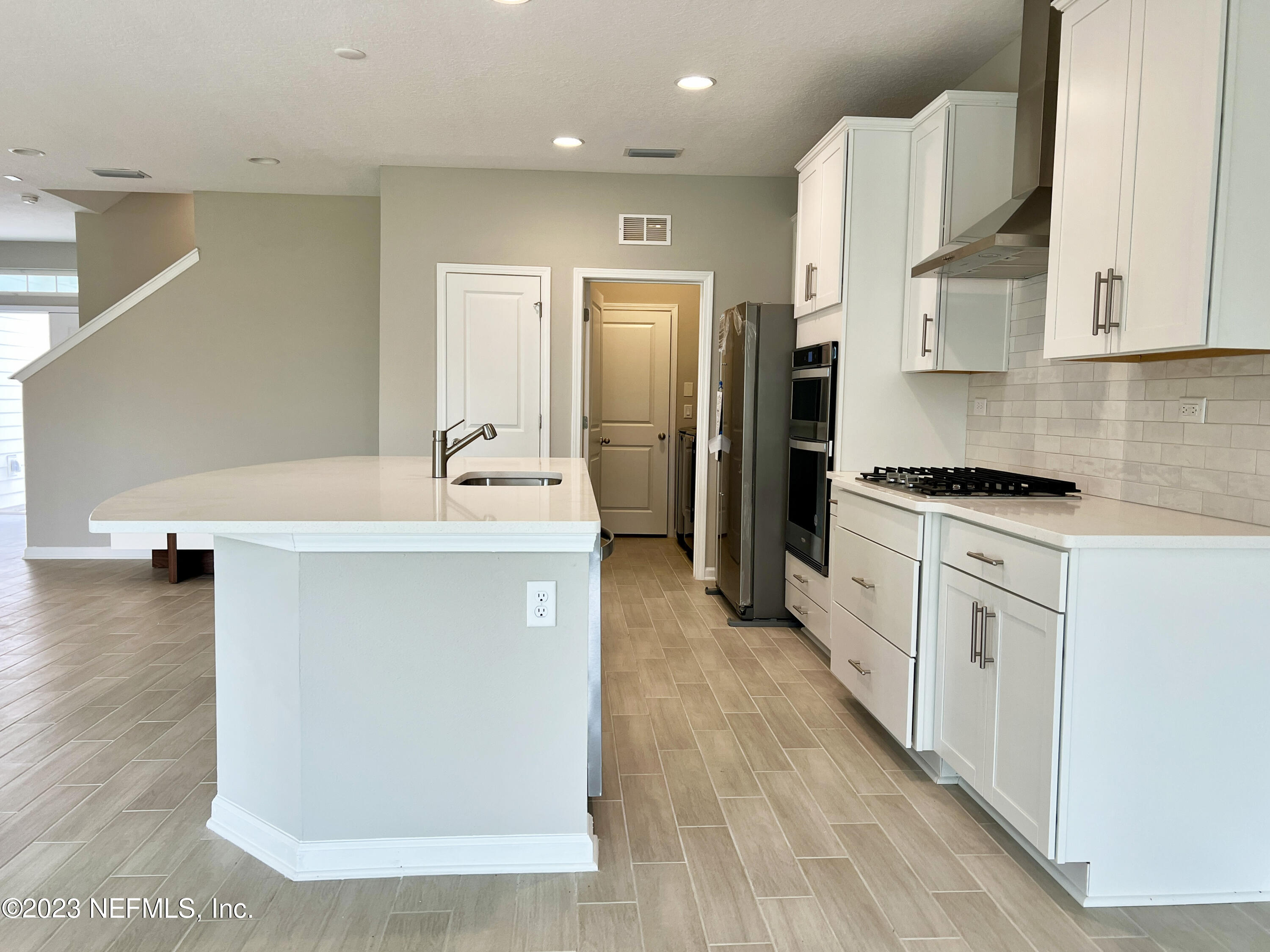 385 Brookgreen Way St. Augustine, FL 32092 - Photo 13 of 32 a kitchen with kitchen island a sink appliances and cabinets