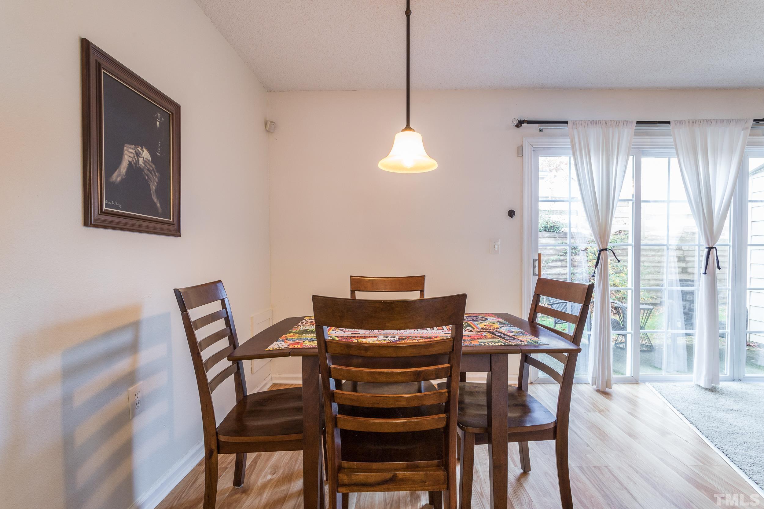 7808 Falcon Rest Circle Raleigh, NC 27615 - Photo 16 of 28 a view of a dining room with furniture window and outside view