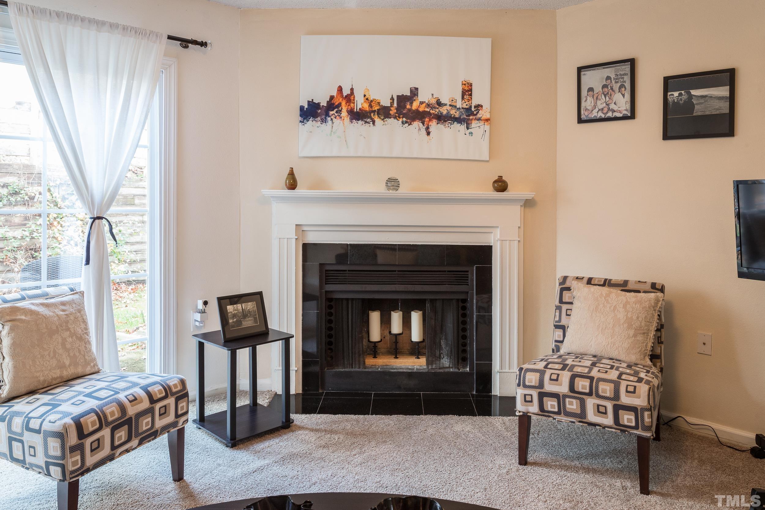 7808 Falcon Rest Circle Raleigh, NC 27615 - Photo 20 of 28 a living room with furniture and a fireplace