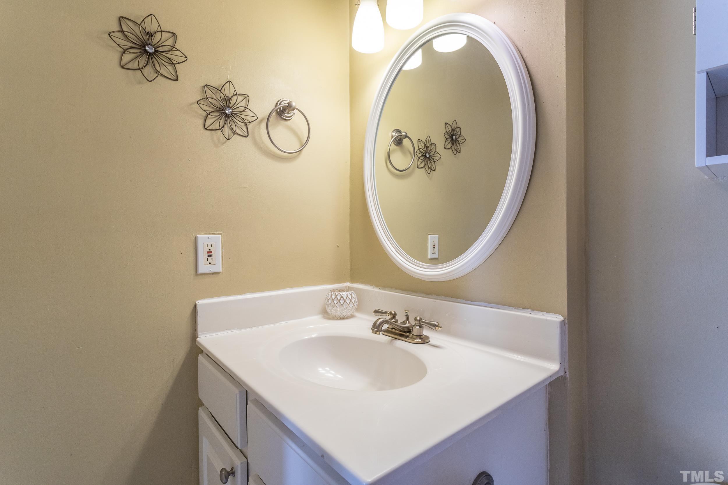7808 Falcon Rest Circle Raleigh, NC 27615 - Photo 3 of 28 a bathroom with a sink mirror and vanity