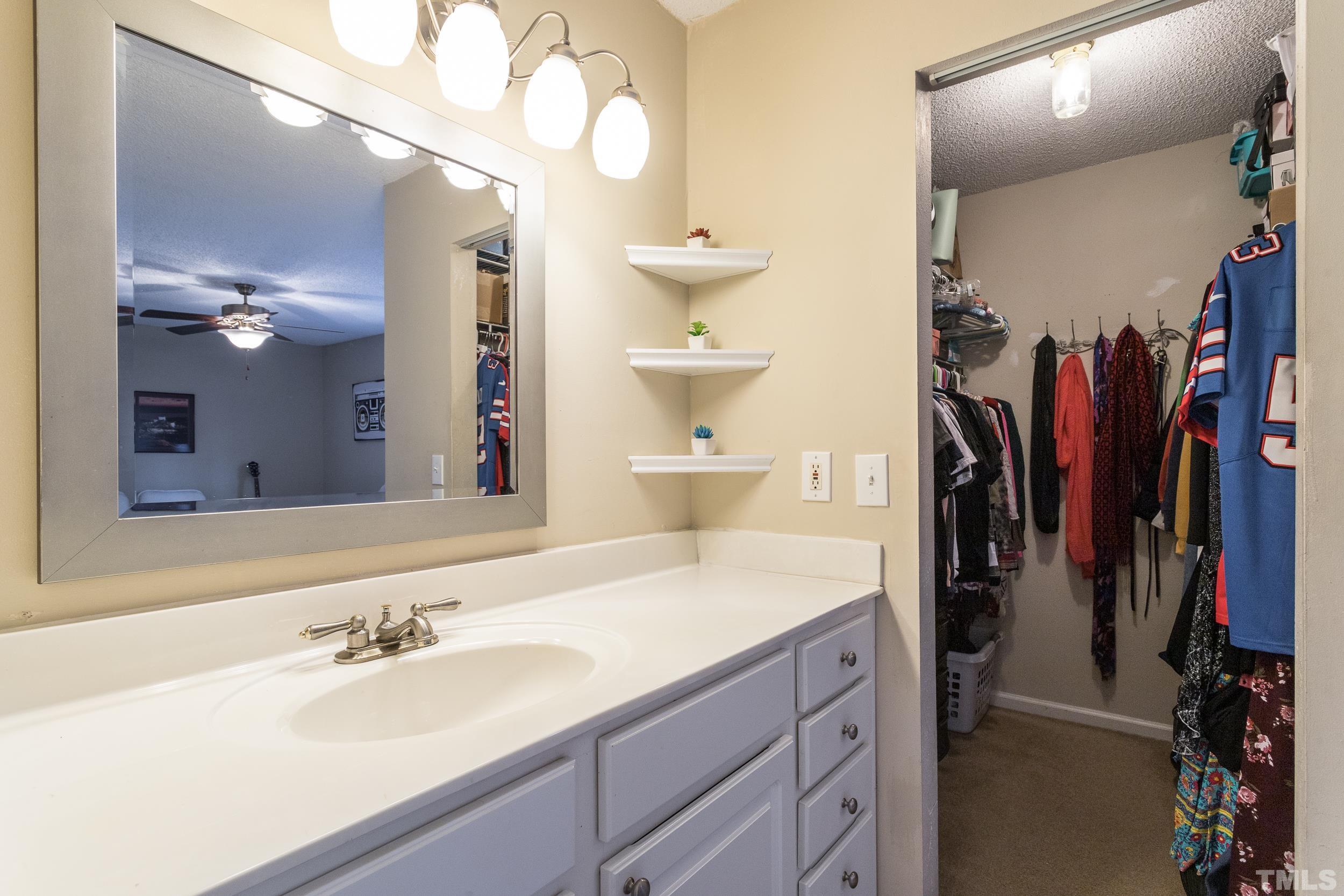 7808 Falcon Rest Circle Raleigh, NC 27615 - Photo 8 of 28 a bathroom with a sink vanity and a mirror