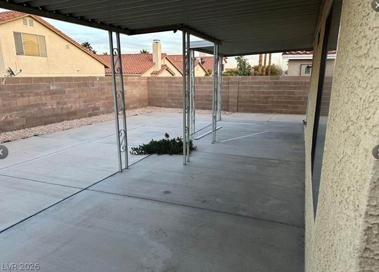 7652 Kalmalii Avenue Las Vegas, NV 89147 - Photo 9 of 9 A spacious backyard patio with a protective awning, perfect for outdoor entertaining.