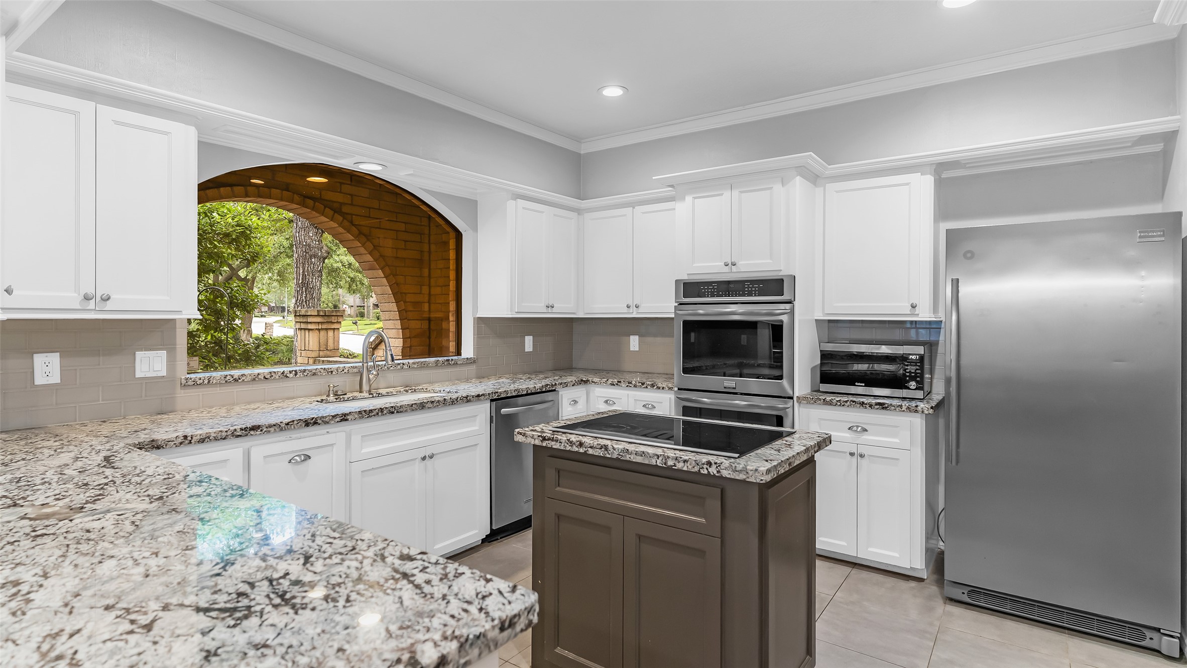 2607 Laurel Ridge Drive Houston, TX 77345 - Photo 14 of 47 a kitchen with a sink stove and microwave