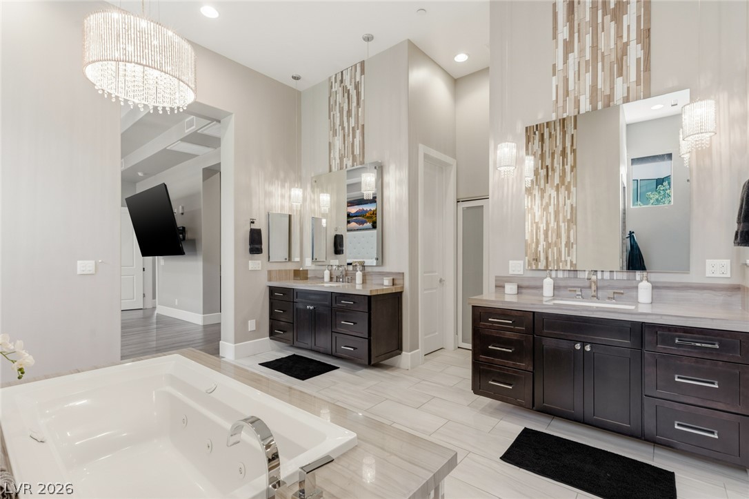 5 Crystal Tree Pass Henderson, NV 89052 - Photo 20 of 67 Luxurious primary bath with double vanity, soaking tub, and stylish tile accents.