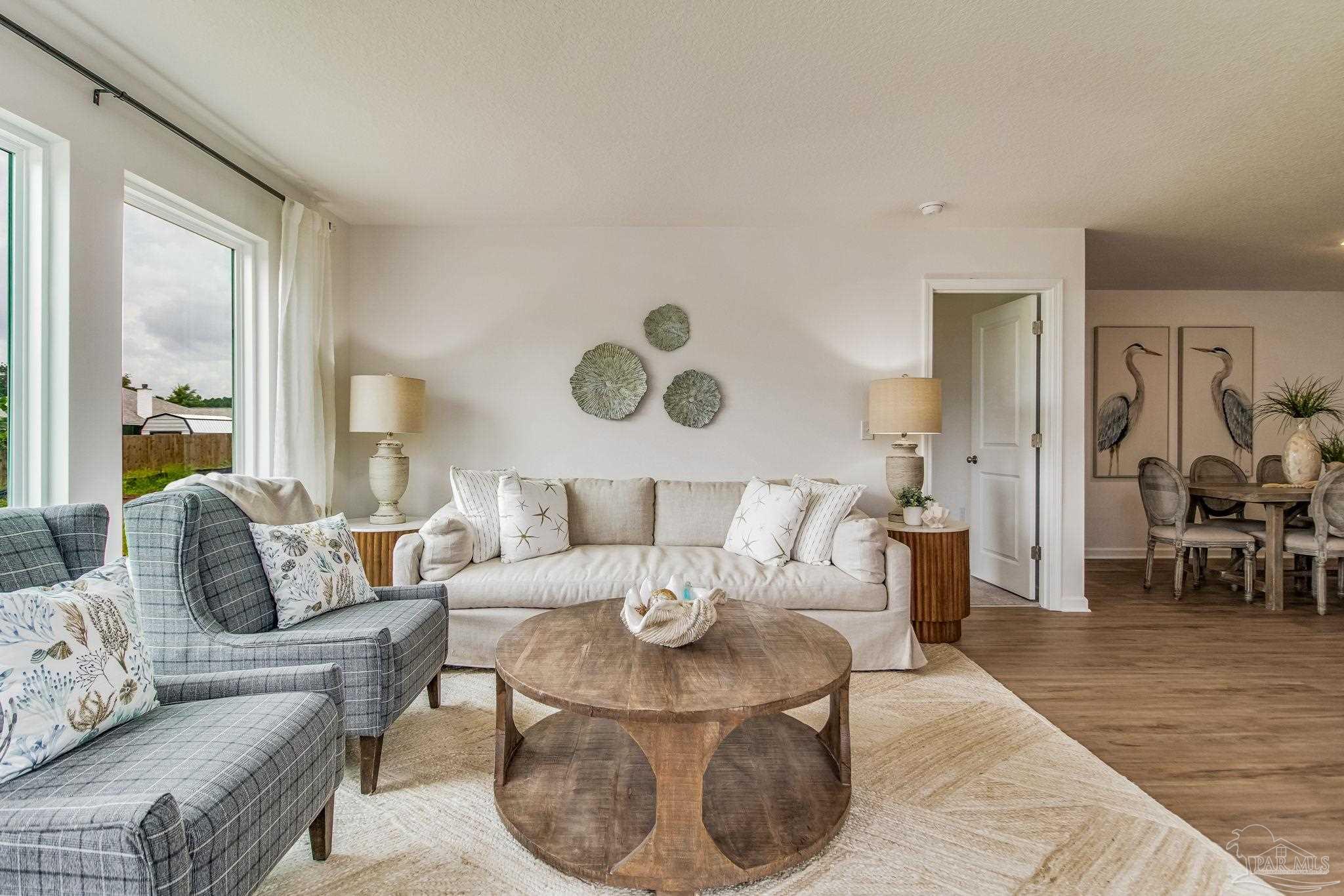 7757 Moonrise Way Milton, FL 32583 - Photo 12 of 27 a living room with furniture and wooden floor