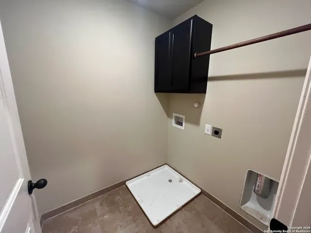 a view of an empty room and a ceiling fan