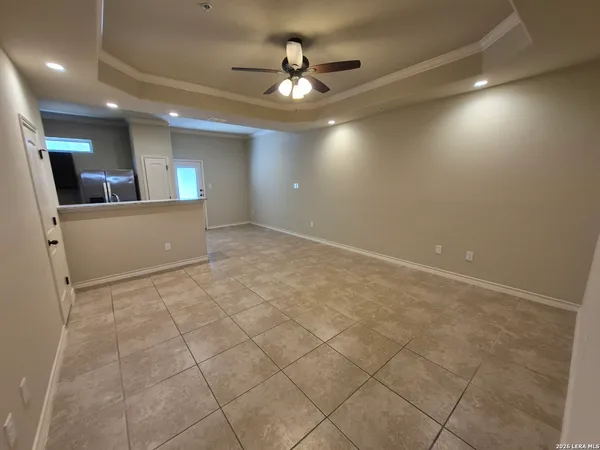 wooden floor in an empty room with a kitchen