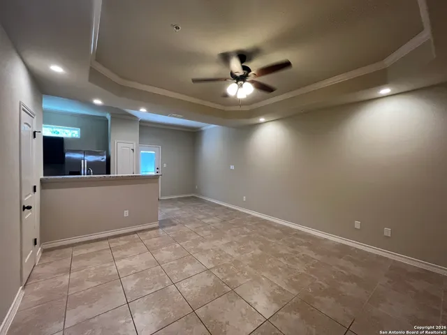 a view of a livingroom with a ceiling fan and window