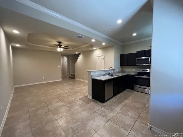 a large kitchen with a large counter top appliances and cabinets