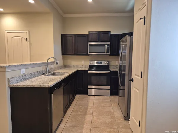 a kitchen with a sink and stainless steel appliances