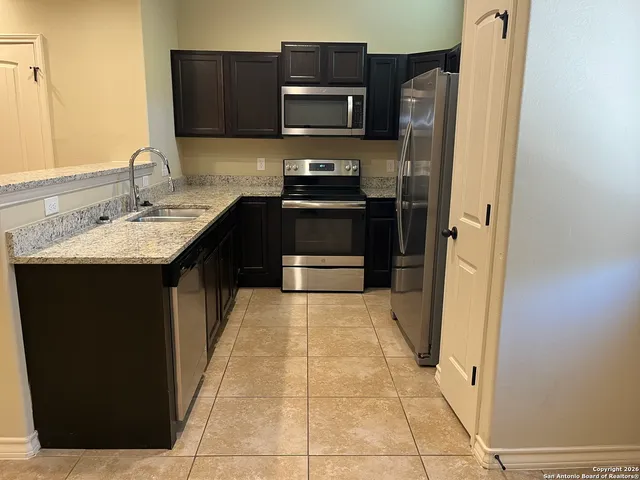 a kitchen with a sink and a refrigerator