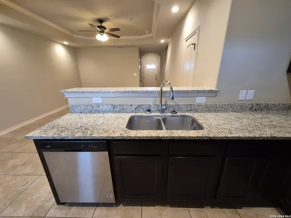 a kitchen with a sink a counter space and cabinets