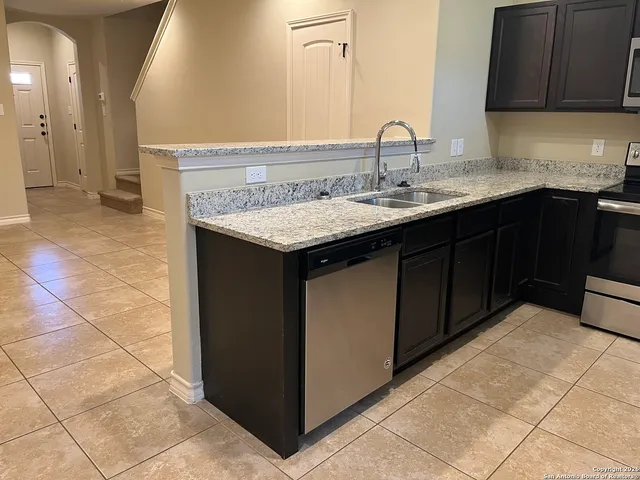a kitchen with a sink and cabinets