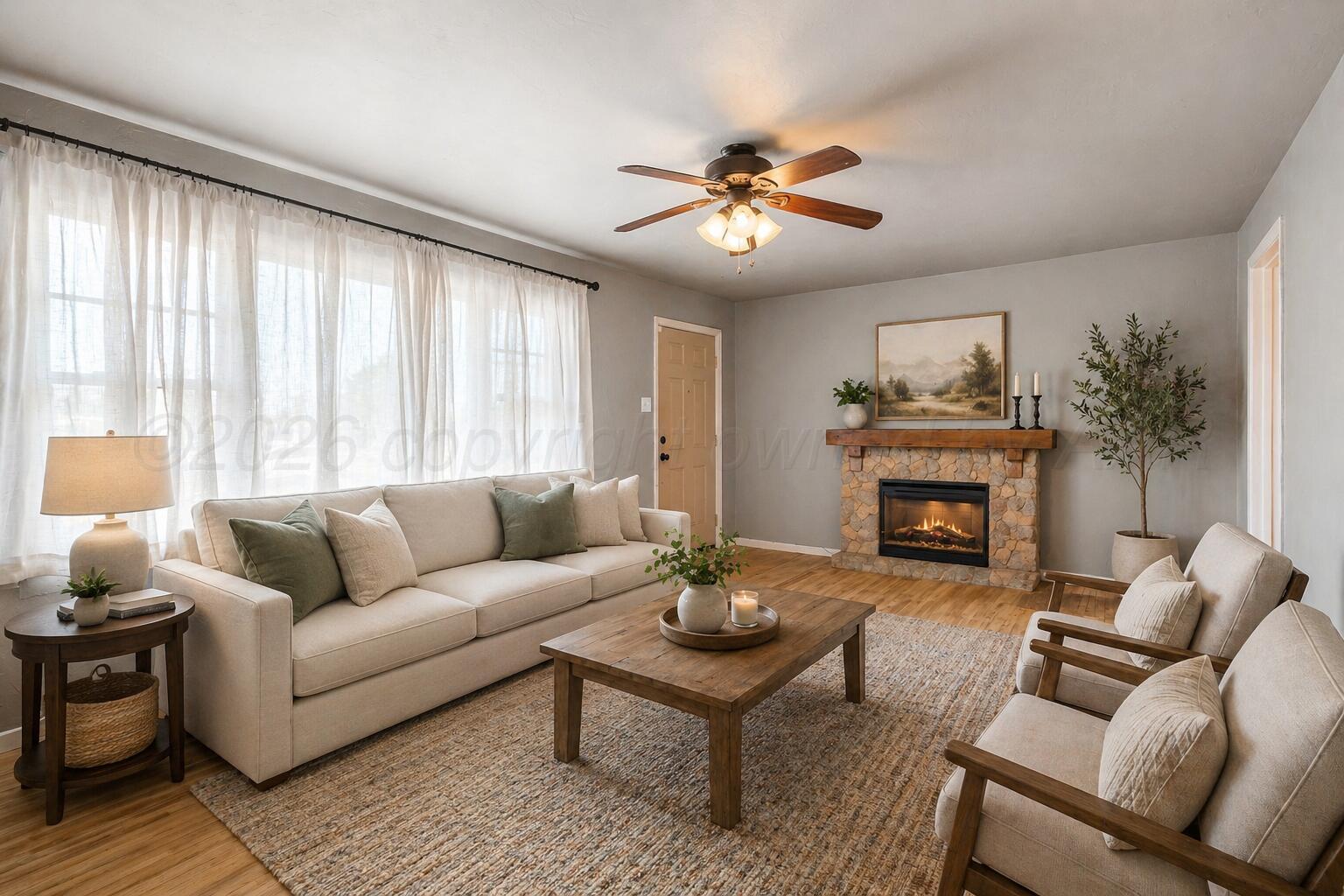 a living room with furniture a fireplace and a large window
