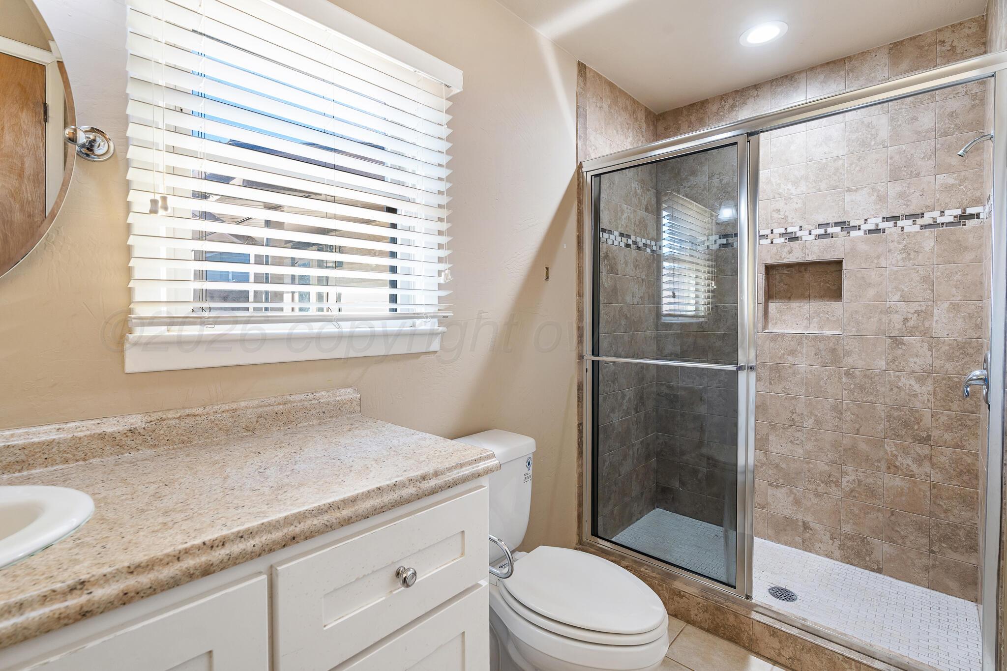 710 North Roberts Street Amarillo, TX 79107 - Photo 13 of 20 a bathroom with a granite countertop sink toilet and shower