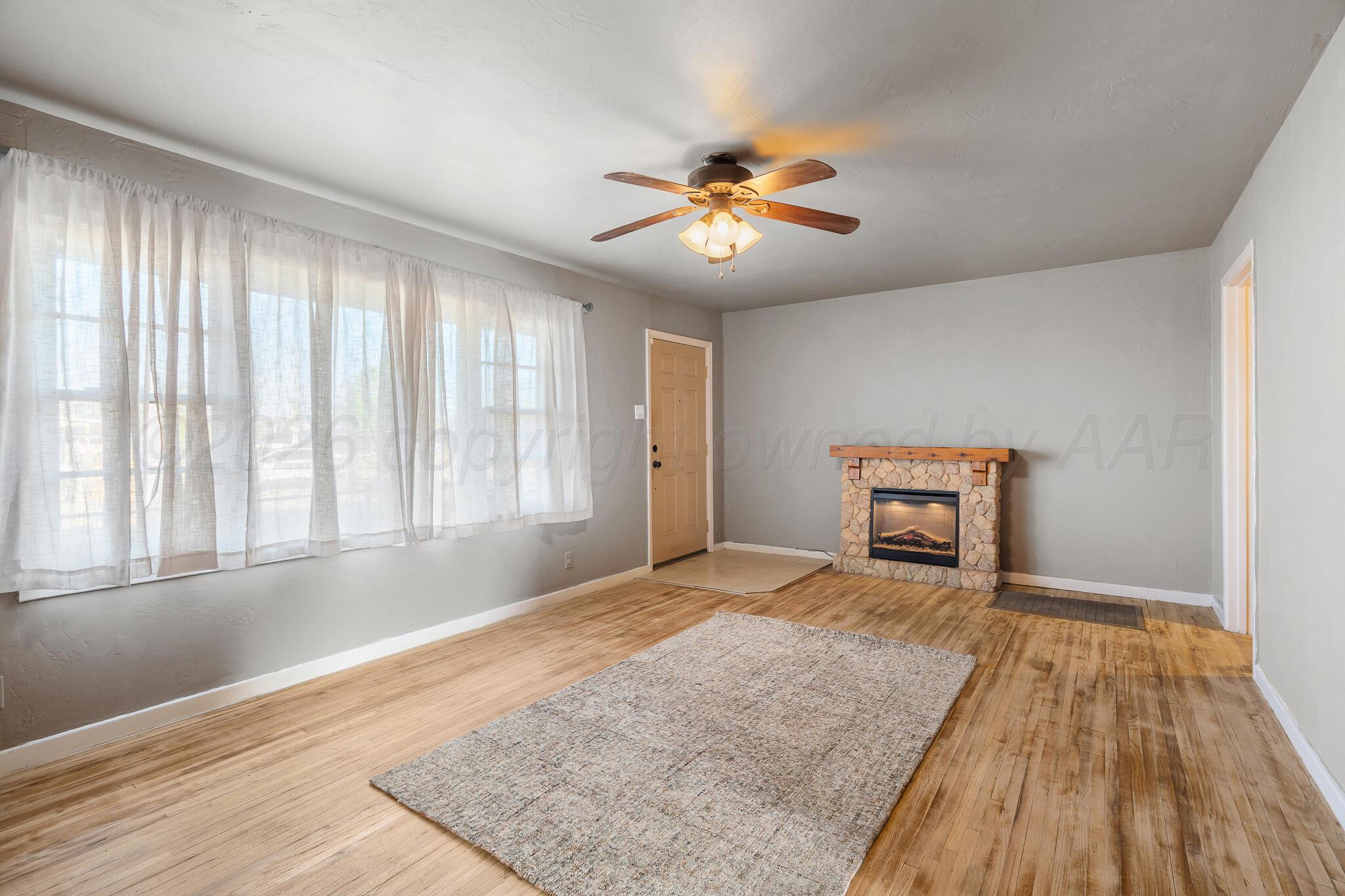 710 North Roberts Street Amarillo, TX 79107 - Photo 2 of 20 a view of an empty room with a window and wooden floor