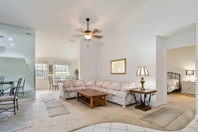a living room with furniture a rug and white walls