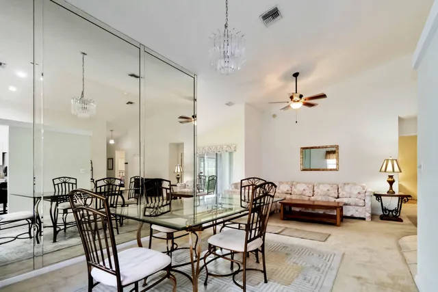 a living room with lots of furniture and a chandelier