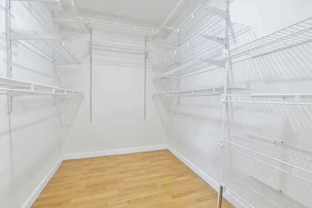 a view of a room with wooden floor