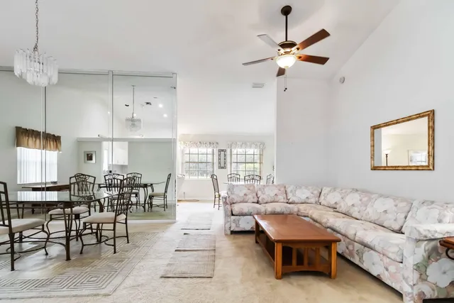 a kitchen with a dining table chairs cabinets and stainless steel appliances