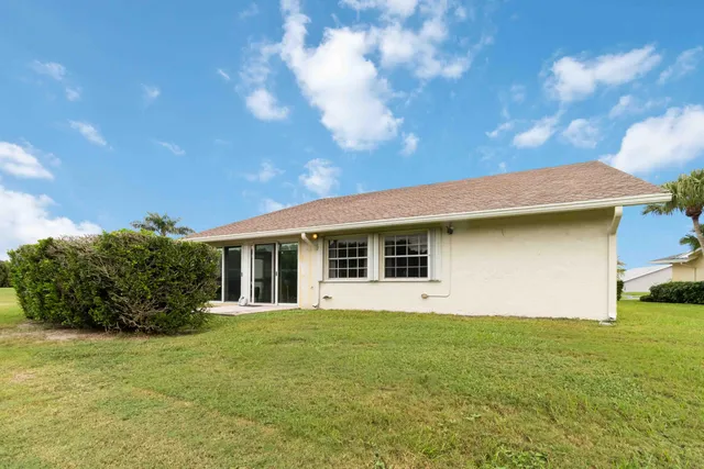 a view of a house with pool and a yard