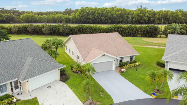 an aerial view of residential houses with outdoor space and swimming pool