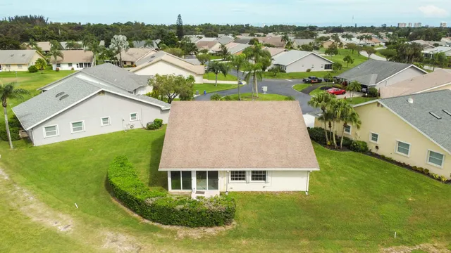 a aerial view of a house with a garden and houses