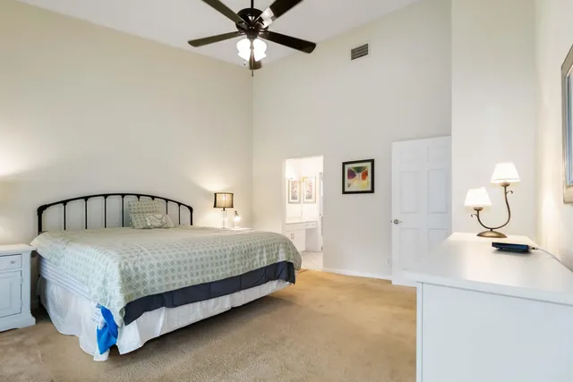 a bedroom with a bed and ceiling fan