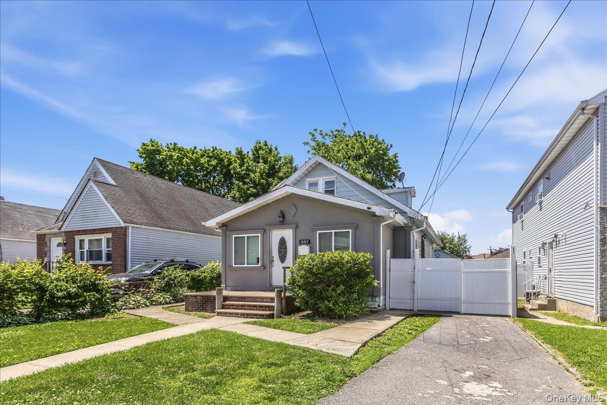 237 Rhodes Avenue Hempstead, NY 11550 - Photo 3 of 24 a house view with a garden space