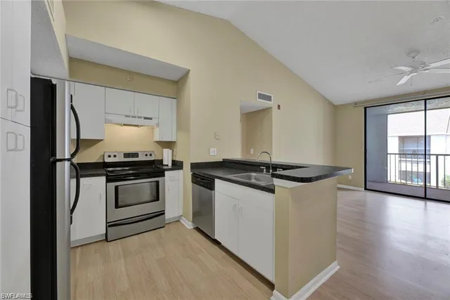 a kitchen with granite countertop a stove and a sink