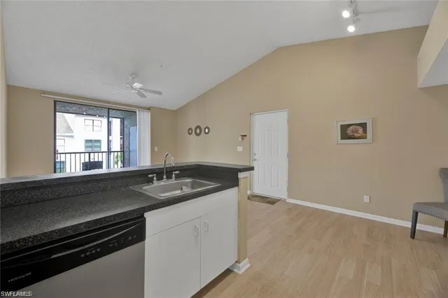 a kitchen with granite countertop a stove and a sink