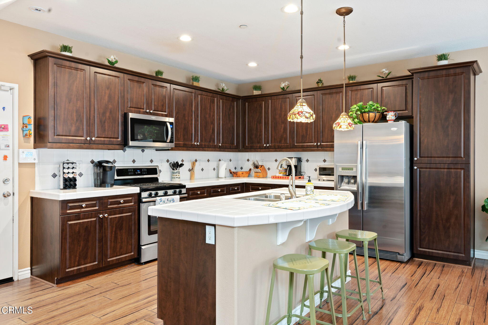 3630 Jolly Roger Way Oxnard, CA 93035 - Photo 9 of 24 a kitchen with kitchen island a sink refrigerator and microwave