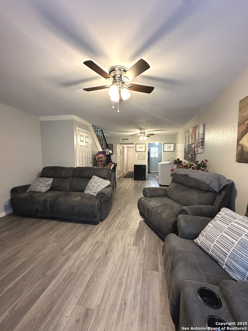 911 Vance Jackson Road, Unit Y San Antonio, TX 78201 - Photo 19 of 40 a living room with furniture ceiling fan and a wooden floor
