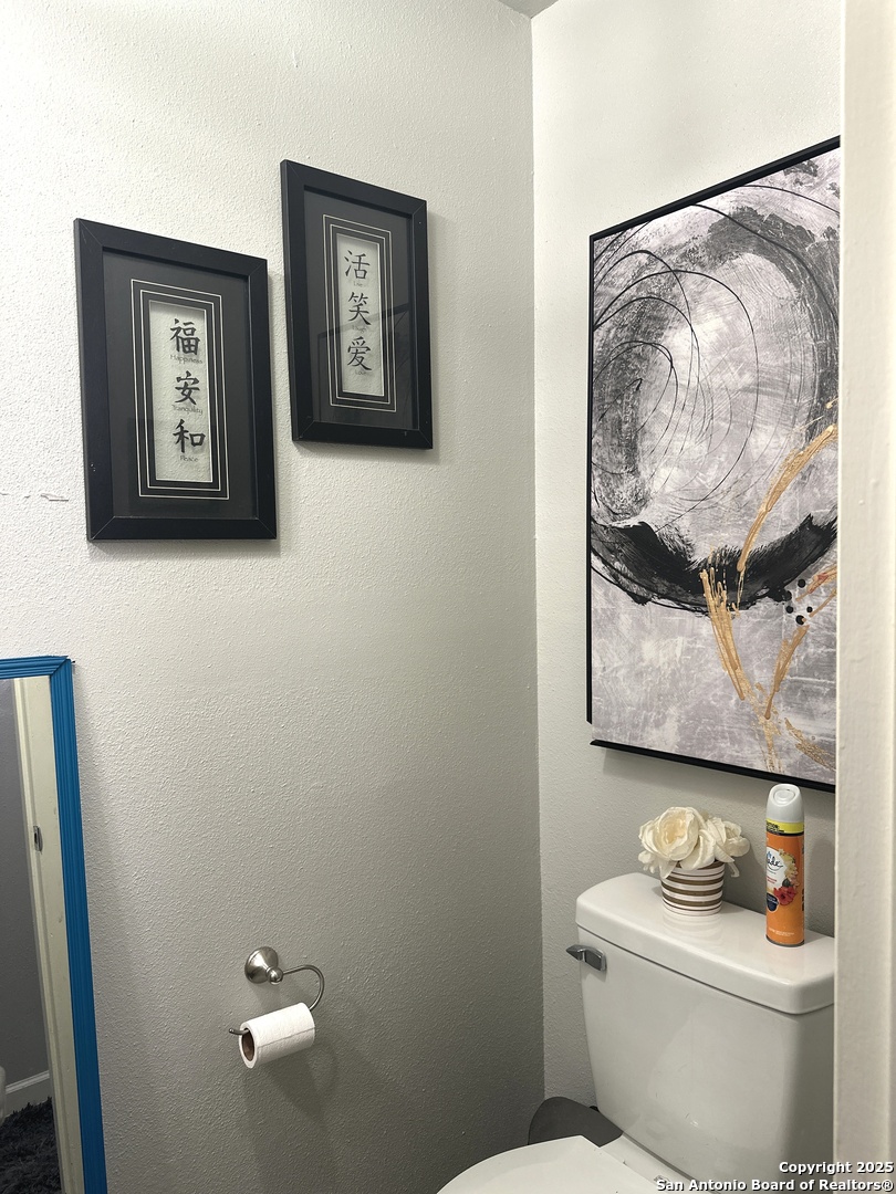 911 Vance Jackson Road, Unit Y San Antonio, TX 78201 - Photo 21 of 40 a white toilet sitting next to a bathroom sink