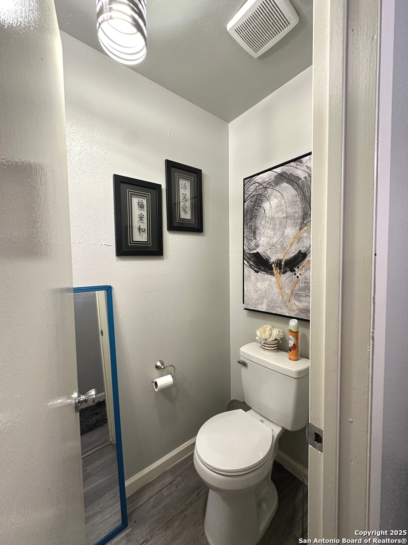 911 Vance Jackson Road, Unit Y San Antonio, TX 78201 - Photo 22 of 40 a white toilet sitting next to a bathroom sink