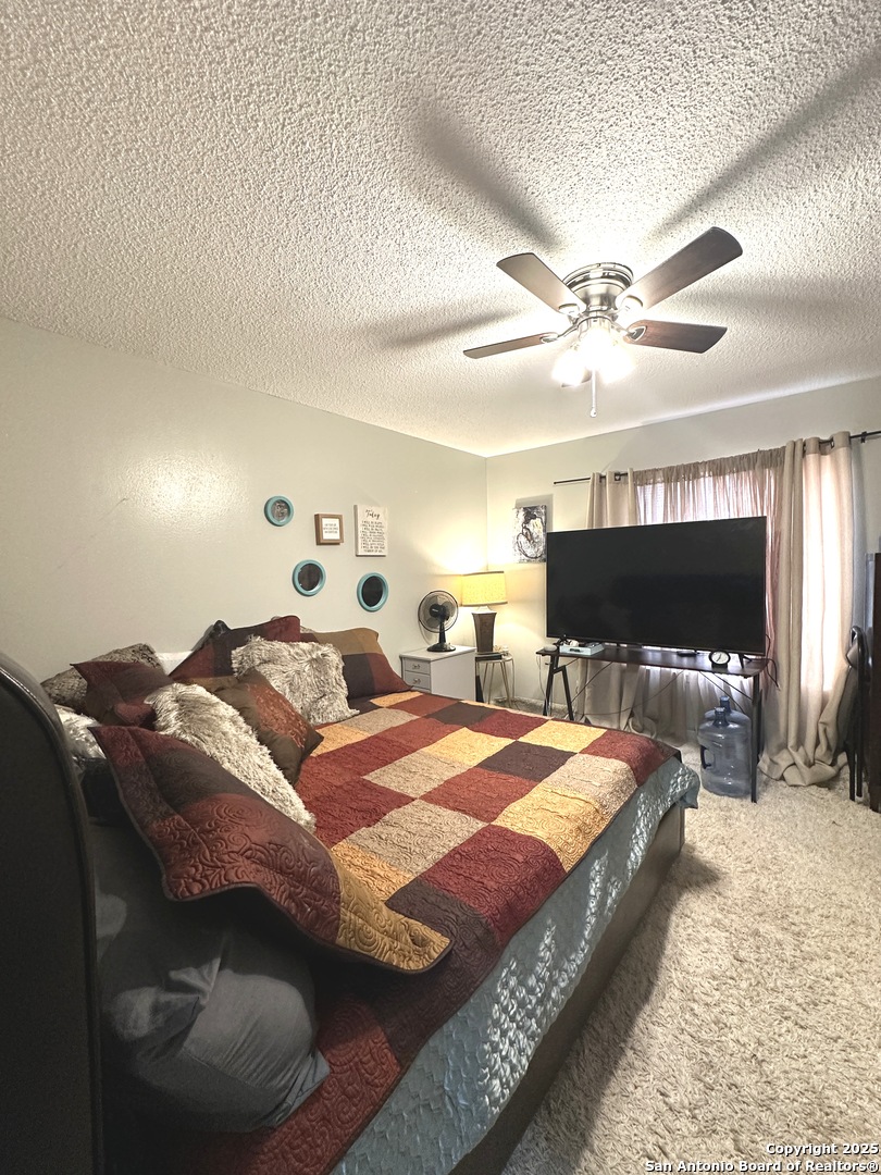 911 Vance Jackson Road, Unit Y San Antonio, TX 78201 - Photo 34 of 40 a spacious bedroom with a bed and a flat screen tv