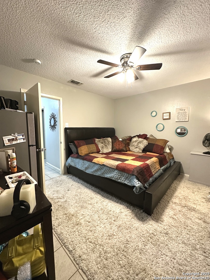 911 Vance Jackson Road, Unit Y San Antonio, TX 78201 - Photo 37 of 40 a bedroom with a bed and closet with wooden floor