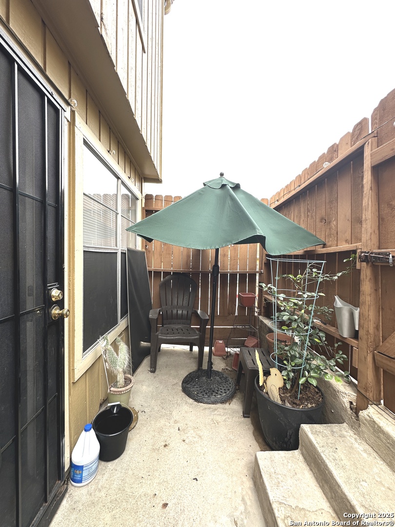 911 Vance Jackson Road, Unit Y San Antonio, TX 78201 - Photo 39 of 40 a view of a patio with couches table and chairs under an umbrella