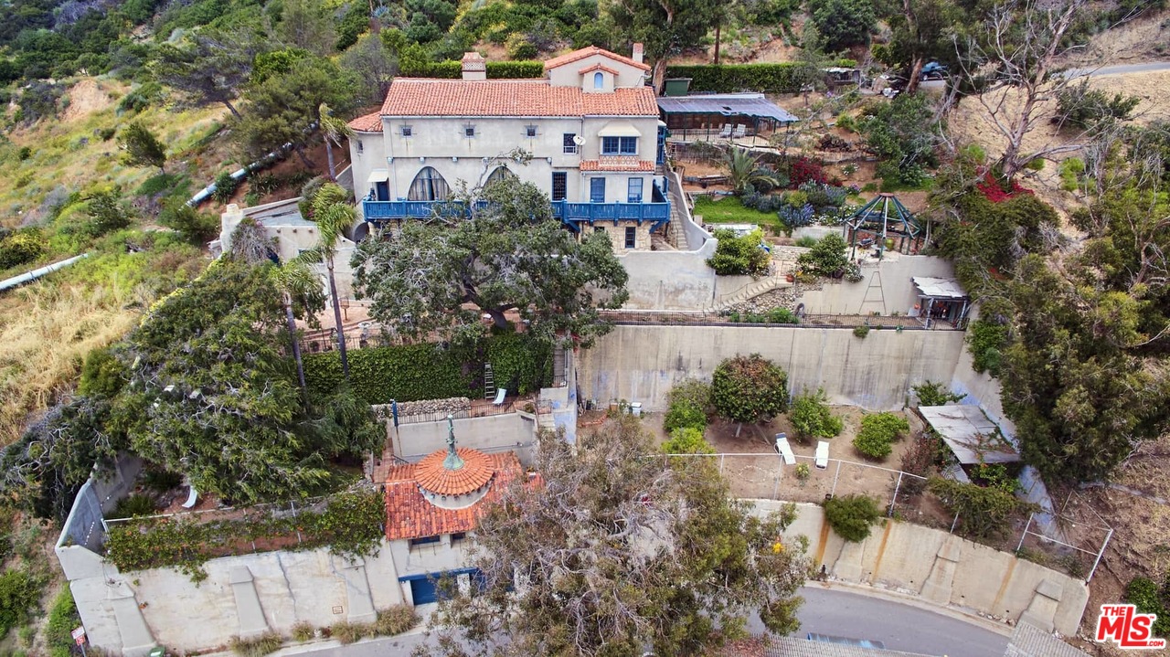 an aerial view of a house with a garden