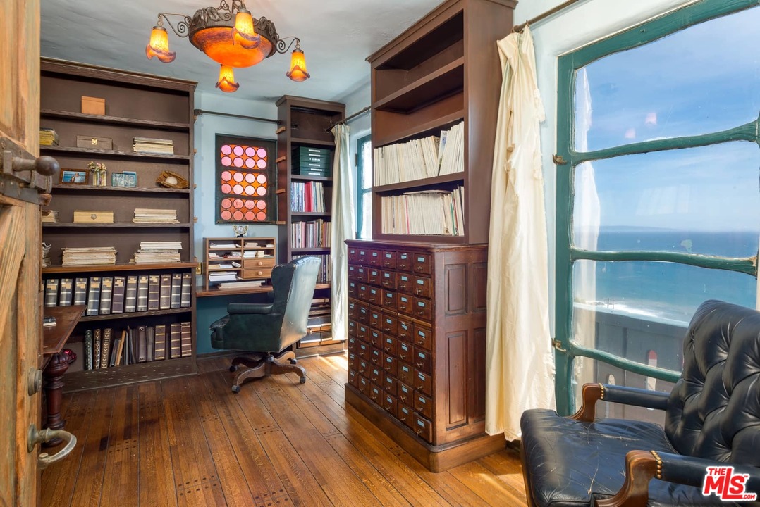 17520 Revello Drive Pacific Palisades, CA 90272 - Photo 23 of 51 a reading room with furniture window and wooden floor