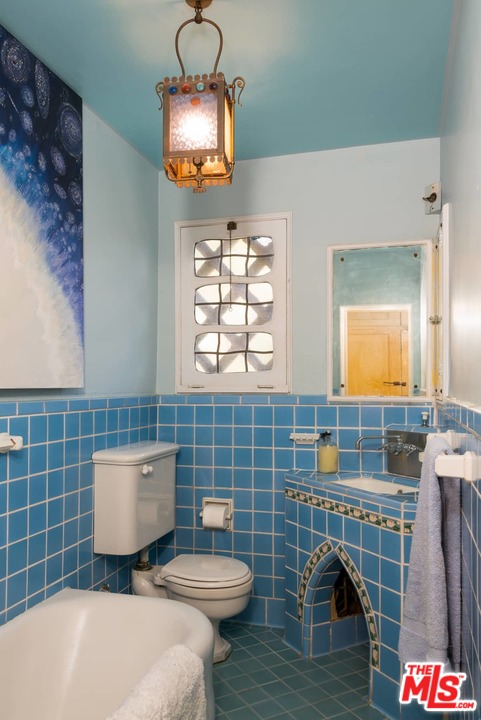 17520 Revello Drive Pacific Palisades, CA 90272 - Photo 24 of 51 a bathroom with a toilet a sink and mirror