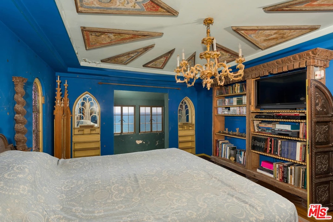 17520 Revello Drive Pacific Palisades, CA 90272 - Photo 30 of 51 a bedroom with furniture and a flat screen tv