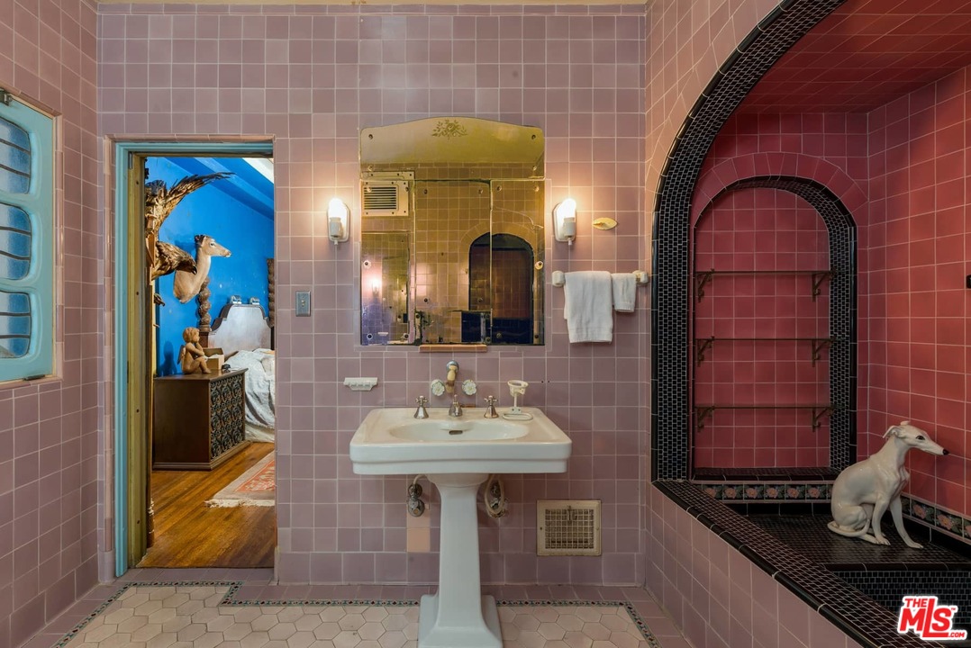 17520 Revello Drive Pacific Palisades, CA 90272 - Photo 33 of 51 a bathroom with a sink and a mirror