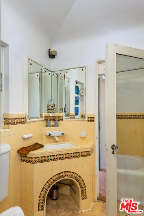 17520 Revello Drive Pacific Palisades, CA 90272 - Photo 43 of 51 a bathroom with a sink mirror vanity and toilet