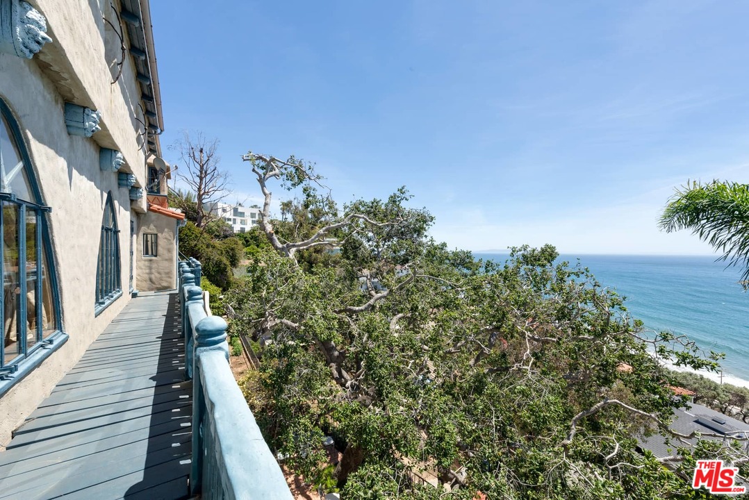 17520 Revello Drive Pacific Palisades, CA 90272 - Photo 44 of 51 a view of a balcony with wooden floor and fence
