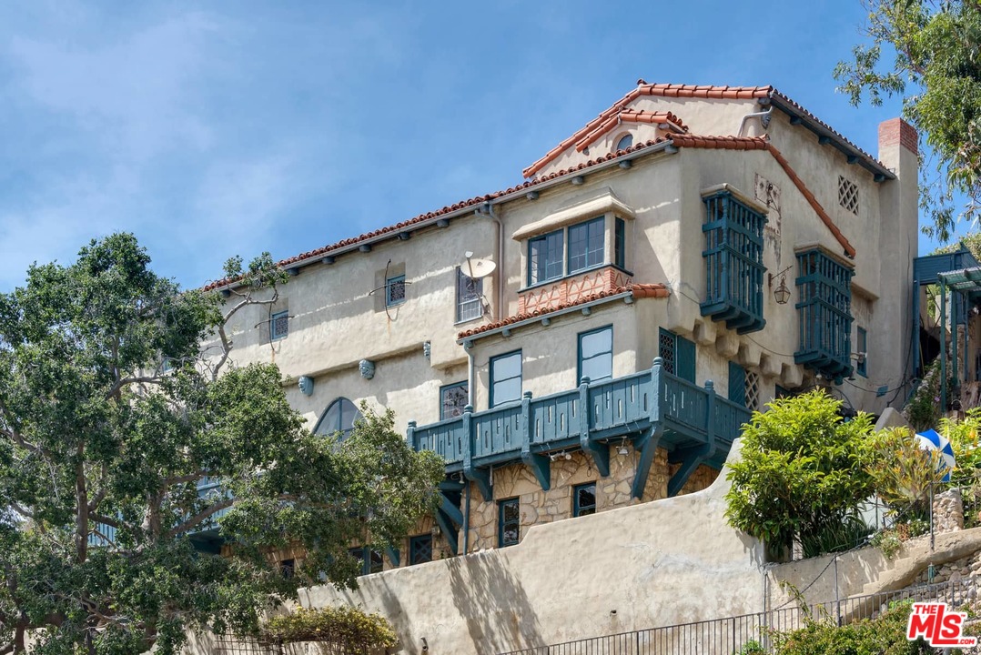 17520 Revello Drive Pacific Palisades, CA 90272 - Photo 47 of 51 a front view of a house with a yard