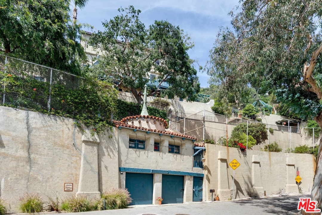 17520 Revello Drive Pacific Palisades, CA 90272 - Photo 6 of 51 a large building with a tree in front of it