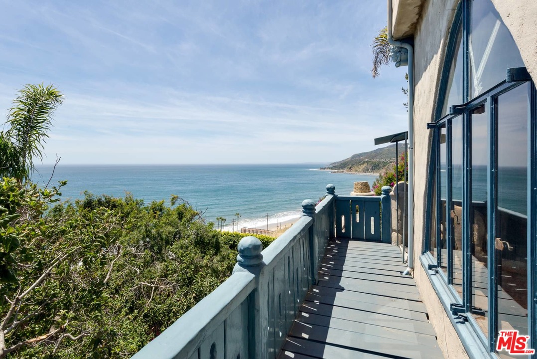 17520 Revello Drive Pacific Palisades, CA 90272 - Photo 8 of 51 a view of a balcony with wooden floor and stairs