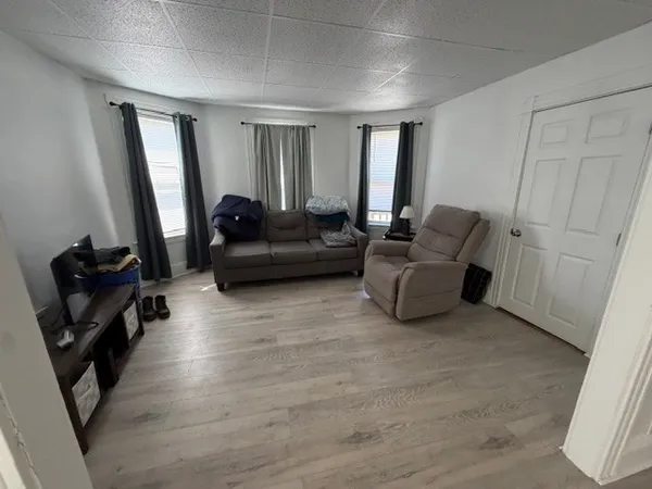 a living room with furniture and a mirror